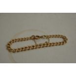 A 9ct gold open link bracelet with attached safety
