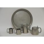 An English pewter tea set with a circular tray,