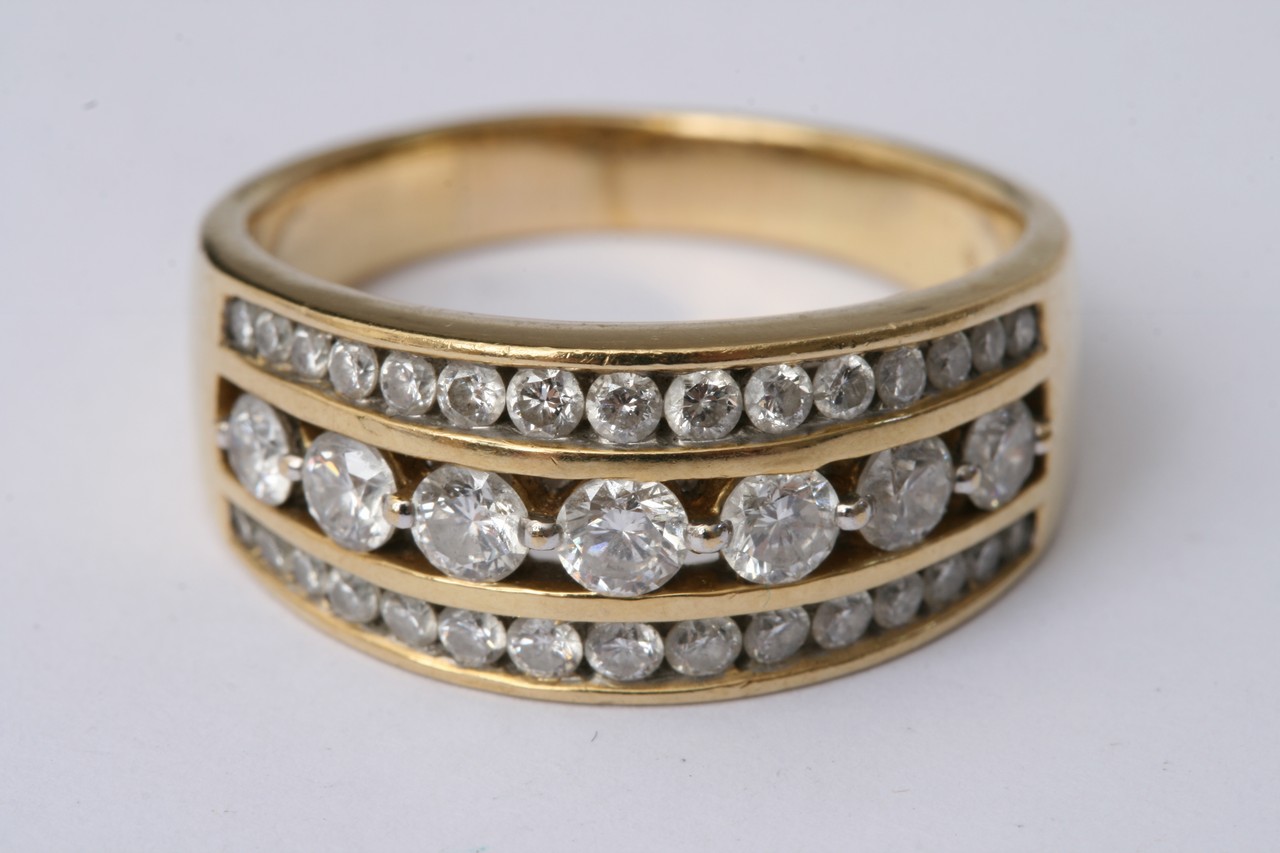 An 18c gold ring set with three rows of diamonds. - Image 2 of 4