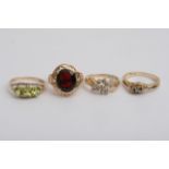 Four gold rings set with coloured stones, approx 9