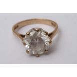 A 9ct gold ring inset with single white stone (siz