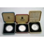 Three cased Commemorative coins.