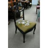 An open back chair with tapestry and beadwork seat