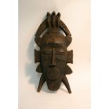 A carved wooden tribal mask.