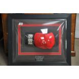 A mounted and framed signed Nigel Benn boxing glov