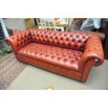 A red leather Chesterfield sofa, approx 188cm x 85