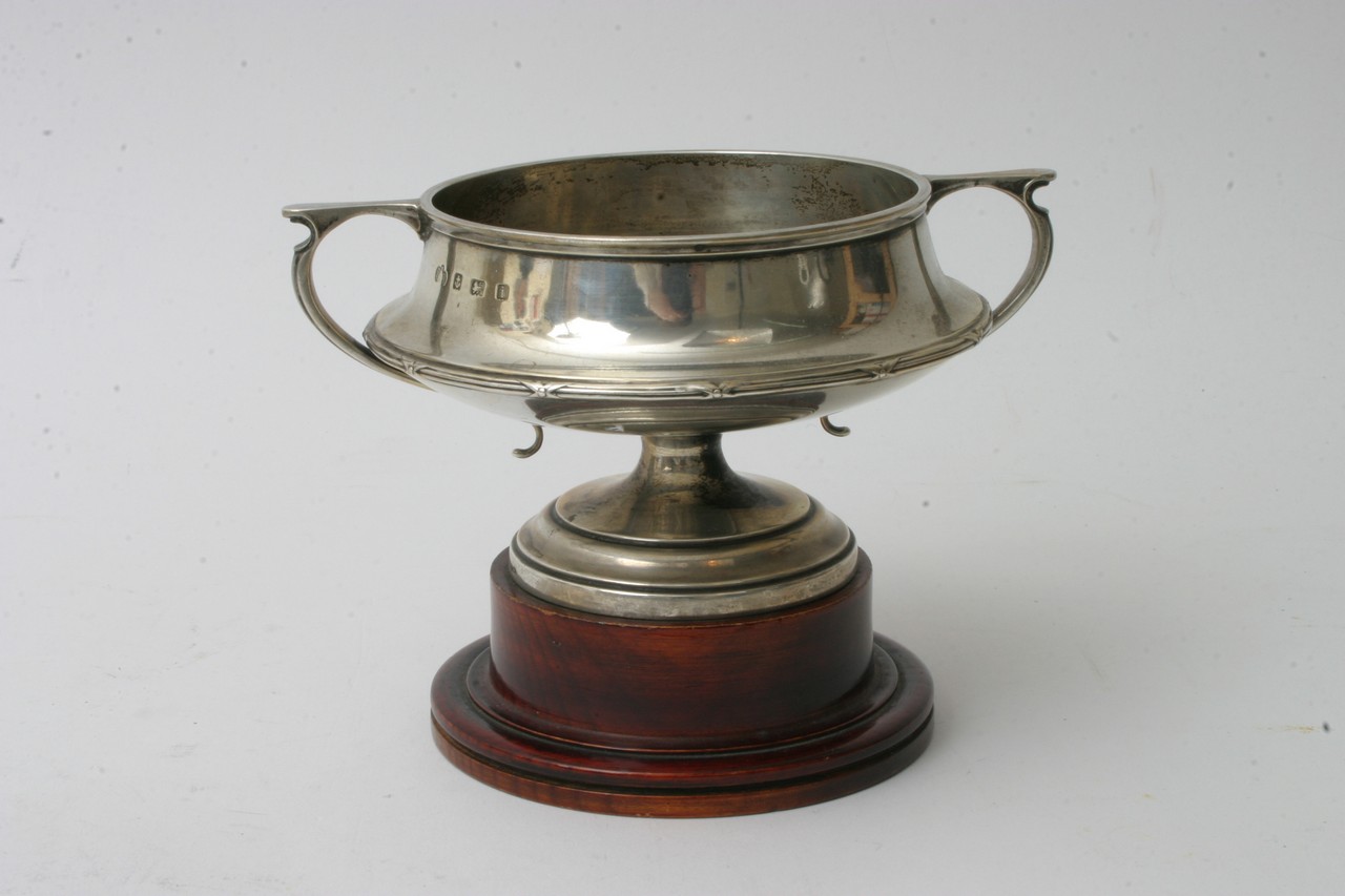 An Elkington silver trophy cup on wooden stand, ap