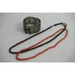 A Vintage silver fillagree bangle a coral necklace