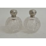 A pair of silver and cut glass scent bottles of sp
