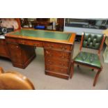 A reproduction leather topped desk, approx 138cm x