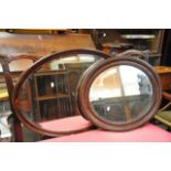 Two mahogany framed oval wall mirrors, approx 61cm