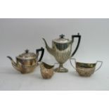 A silver Four piece tea set with ebony fittings ha