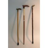 Three walking sticks including one with bone decor