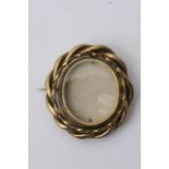 An oval shaped pinchbeck mourning brooch