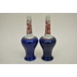 A pair of Chinese long necked vases having blue gr