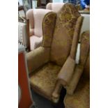 A wing back open armchair on cabriole legs with ba