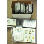 A box containing GB first day covers and an album