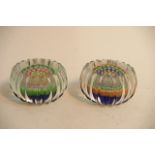 A pair of small shaped millefiori paperweights.