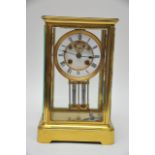 A brassed cased Four glass clock clock fitted with