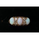 A Vintage 18ct gold ring set with three opals ring