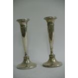 A pair of silver candle sticks with circular bases