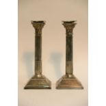 A large pair of silver Corinthian candlesticks, Lo