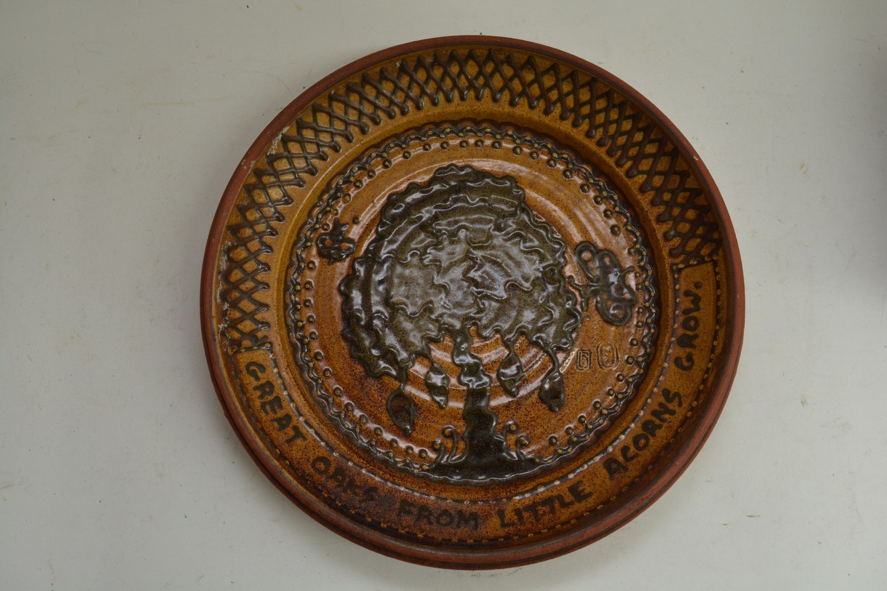 An art pottery dish bearing the phrase 'Great oaks