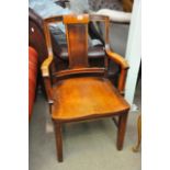 An oak open armchair, possibly marine furniture.