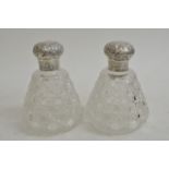 A pair of Victorian silver caped scent bottles of