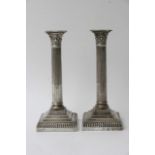 A pair of silver coltham column candlesticks with