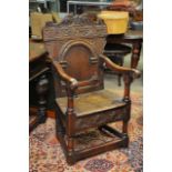 A 17th Century ornately carved oak chair, approx height 111cm x 58cm x 57cm.