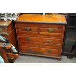 A walnut chest of drawers, fitted with two short a