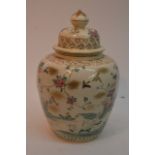 An Oriental jar and cover with hand painted decora