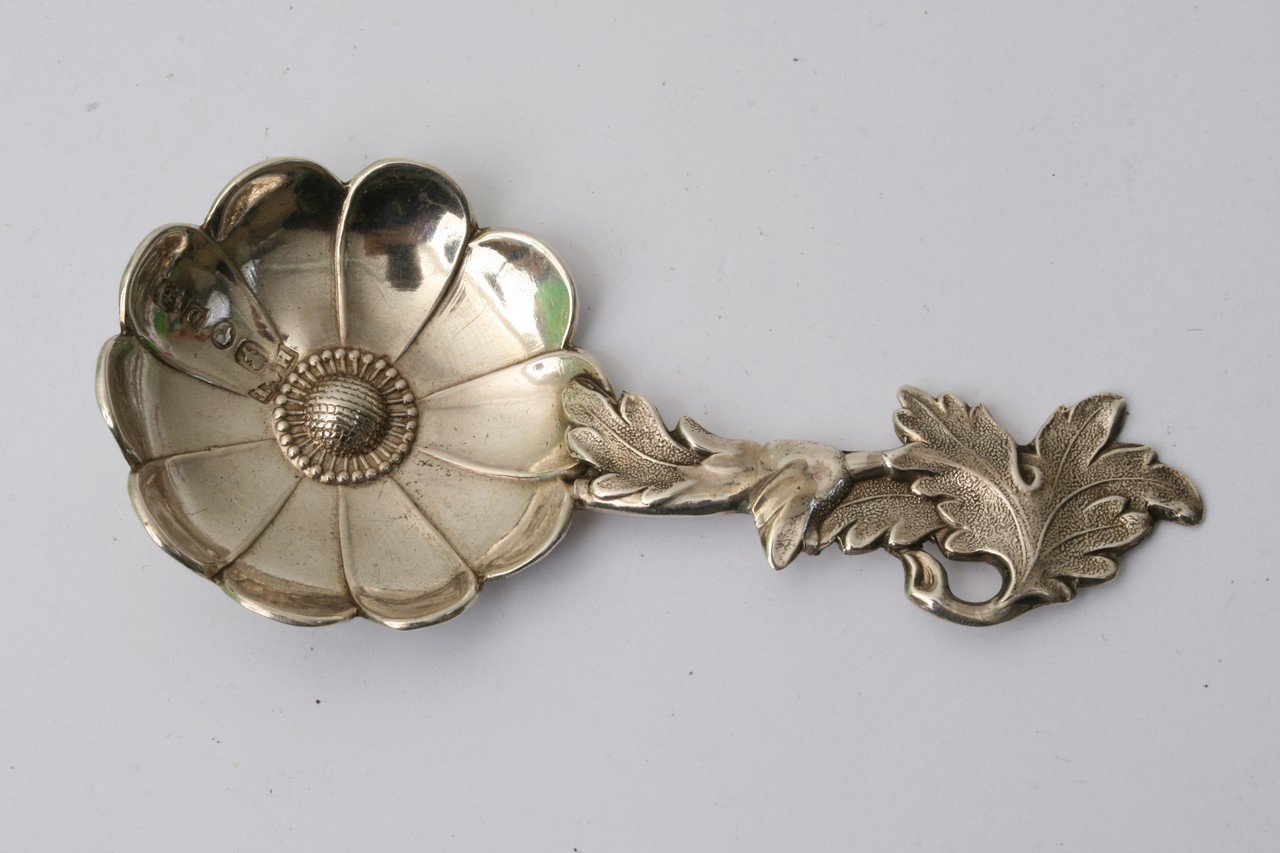 A Victorian silver caddy spoon shaped as a flower,