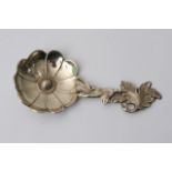 A Victorian silver caddy spoon shaped as a flower,