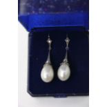A pair of pearl and diamond drop earrings in an 18