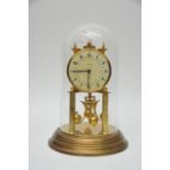 An Anniversary Clock under glass dome the dial wit