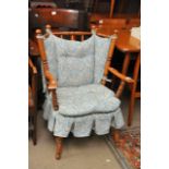 A turned wood chair with blue floral cushion seat