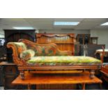 A Victorian Mahogany Chaise lounge with carved scrolled back on turned legs