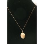 A 9ct gold locket and chain. boxed