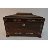 A rosewood sarcophagus shaped tea caddy inlaid wit