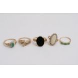 Five gold rings set with coloured stones including
