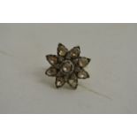 An antique diamond ring in the form of a flowerhea