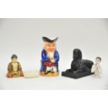 A collection of itmes including a black sphinx, a