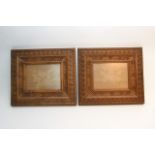 A pair of ornately carved wooden picture frames, a