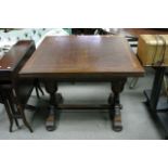 A 1930's oak drawer leaf table, approx 91cm x 91cm