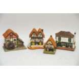 Four musical boxes formed as cottages