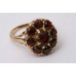 A 9ct gold ring inset with a clustre of garnets