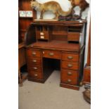 An oak roll top desk, approx 70cm x 107cm x 119cm.