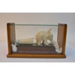 A cased antique carved ivory model of an elephant